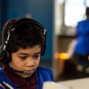 Male student wearing a headset participates in the Virtual Missions